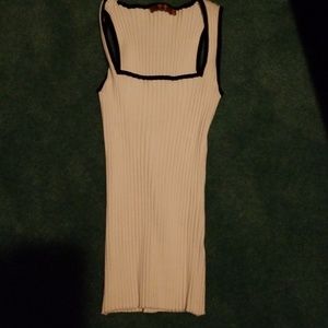 White ribbed top with black piping.